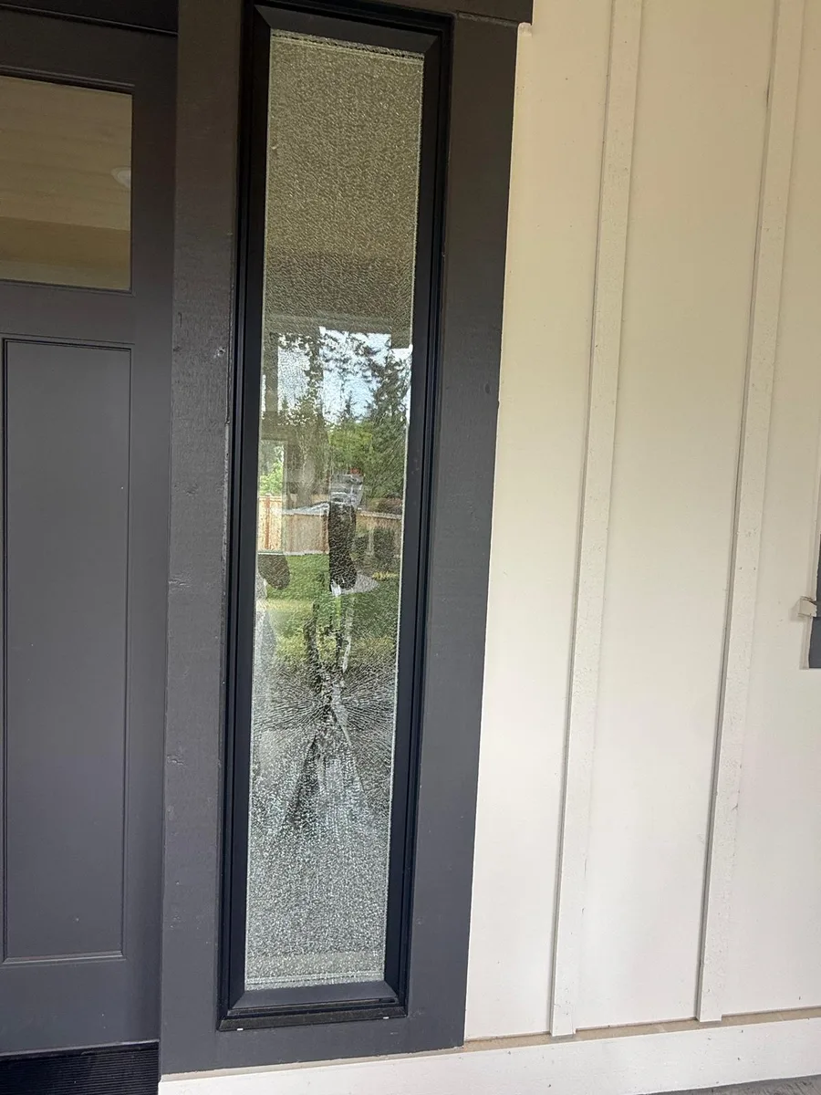 Broken residential entry door sidelight glass